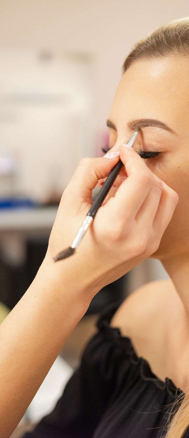 Woman having make-up done